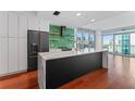 Modern kitchen with marble countertops, stainless steel appliances, and green geometric backsplash at 912 Channelside Dr # 2607, Tampa, FL 33602
