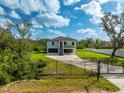 Modern home with driveway and black metal gate at 2316 S 46Th St, Tampa, FL 33619
