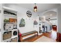 Entryway with built-in bench, hooks, and shelves; view into living room at 2616 Garden Plum Pl, Odessa, FL 33556