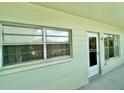 Condo exterior, light green building with white trim and doors at 2385 Tahitian Ln # 63, Clearwater, FL 33763