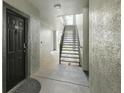 Interior hallway with dark door and metal staircase at 13113 Sanctuary Cove Dr # 104, Temple Terrace, FL 33637