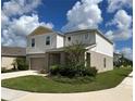 Two story house with light beige siding and teal door at 13116 Shumard Way, Riverview, FL 33579