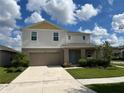 Two story house with light beige siding and teal door at 13116 Shumard Way, Riverview, FL 33579