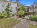 Building exterior with lush landscaping and walkway at 300 S Florida Ave # 500C, Tarpon Springs, FL 34689
