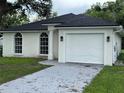 Newly built home with white exterior and landscaping at 8518 N Edison Ave, Tampa, FL 33604