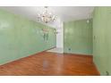 Simple dining room with light green walls and wood floors at 3919 W Palmetto St, Tampa, FL 33607