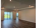 Spacious living room features wood floors, recessed lighting, access to lanai via sliding doors at 10736 Tippecanoe Pl, Parrish, FL 34219