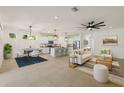 Bright, open-concept living space with tile flooring, dining area, kitchen island, and modern furnishings at 11892 Frost Aster Dr, Riverview, FL 33579