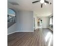 Open living room with hardwood floors and views to kitchen at 18141 Sandy Pointe Dr, Tampa, FL 33647