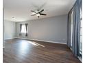 Spacious living room featuring hardwood floors and large windows at 18141 Sandy Pointe Dr, Tampa, FL 33647