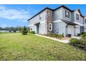 Side view of townhome with stone accents at 7014 Ripple Pond Loop, Zephyrhills, FL 33541