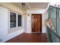 Inviting entryway with rich wood door and tile flooring at 1030 Bellasol Way # 201, Apollo Beach, FL 33572