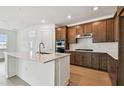 Modern kitchen featuring an island, stainless steel appliances, and wooden cabinets at 13715 Brookside Haven St, Riverview, FL 33578