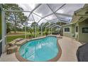 Inviting screened pool with a waterfall feature and lounge chairs at 10926 Sailbrooke Dr, Riverview, FL 33579