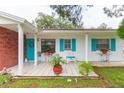 Inviting front porch with tiled flooring and potted plants at 6515 Los Altos Way, Tampa, FL 33634