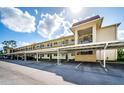 Exterior view of building with covered parking at 1450 Heather Ridge Blvd # 107, Dunedin, FL 34698