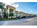 Exterior view of building with covered parking and landscaping at 1450 Heather Ridge Blvd # 107, Dunedin, FL 34698