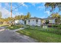 House exterior showcasing a front yard, and driveway with a chain link fence at 906 Jurgens St, Clearwater, FL 33755