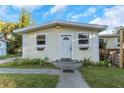 House exterior with a white door, landscaping, and walkway at 906 Jurgens St, Clearwater, FL 33755