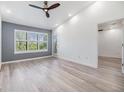 Bright main bedroom with gray accent wall, wood floors and ceiling fan at 11901 4Th N St # 11305, St Petersburg, FL 33716