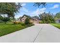 Three car garage with a long driveway at 15212 Kestrelrise Dr, Lithia, FL 33547