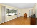 Living room featuring hardwood floors and a large window at 1959 Harding St, Clearwater, FL 33765