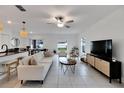 Bright living room featuring a white couch and stylish decor at 6406 Bar S Bar Trl, Zephyrhills, FL 33541