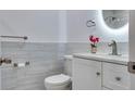 Modern bathroom with white vanity and gray tile at 11452 81St Pl, Seminole, FL 33772