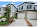 Two-story townhouses with attached garages and landscaping at 2166 Great Sapphire Ln, Lutz, FL 33558