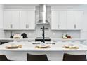 Modern kitchen with white shaker cabinets, quartz countertops, and stainless steel appliances at 412 W Paris St, Tampa, FL 33604