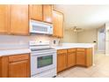 Cozy kitchen featuring wooden cabinets, modern appliances, and a bright, open design at 12820 Belvedere Song Way, Riverview, FL 33578