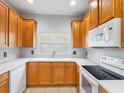 Bright kitchen with wooden cabinets, white countertops, stainless steel appliances, and natural light at 12820 Belvedere Song Way, Riverview, FL 33578