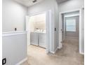 Convenient upstairs laundry room featuring a modern washer and dryer at 12820 Belvedere Song Way, Riverview, FL 33578