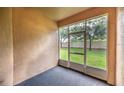 Enclosed patio with screen windows and a view of the manicured backyard and lush green lawn at 12820 Belvedere Song Way, Riverview, FL 33578