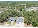 Aerial view of homes nestled among lush trees and natural surroundings at 4729 Majestic Hills Loop, Brooksville, FL 34601