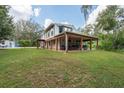 Exterior view of the house, showcasing its side and backyard area at 12805 Flint Creek Rd, Thonotosassa, FL 33592