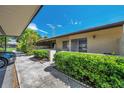 Exterior view of condo, showing manicured landscaping and covered parking at 1308 13Th Se Cir, Largo, FL 33771