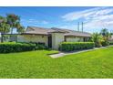 Condo exterior with a well-maintained lawn and landscaping at 1308 13Th Se Cir, Largo, FL 33771