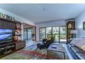 Comfortable living room with a large TV, leather furniture, and backyard access at 5333 Cobblestone Ct, Wesley Chapel, FL 33543