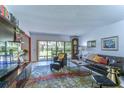 Comfortable living room with a large TV, leather furniture, and backyard access at 5333 Cobblestone Ct, Wesley Chapel, FL 33543