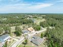 Stunning aerial view of the neighborhood featuring lush greenery and a golf course and pond at 4880 Hickory Oak Dr, Brooksville, FL 34601