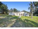 House exterior showcasing a walkway and lawn at 18724 Sugarberry Ln, Spring Hill, FL 34610