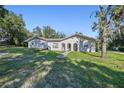 House exterior with a landscaped yard at 18724 Sugarberry Ln, Spring Hill, FL 34610