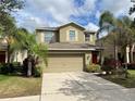 Two-story house with a two-car garage and a red front door at 2126 Richwood Pike Dr, Ruskin, FL 33570
