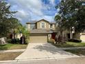 Two-story house with a two-car garage and a red front door at 2126 Richwood Pike Dr, Ruskin, FL 33570
