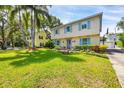 Charming two-story home with blue shutters and a well-manicured lawn and garden at 1229 S Roxmere Rd, Tampa, FL 33629