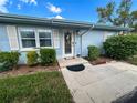 Light blue condo with well-maintained landscaping and walkway at 216 Gloucester Blvd # 216, Sun City Center, FL 33573