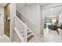 Modern staircase with white railing and gray steps leading to the second floor at 10012 Corso Milano Dr, Tampa, FL 33625