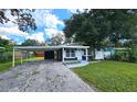 House exterior showcasing a freshly painted navy blue facade and carport at 10007 N 22Nd St, Tampa, FL 33612