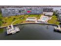 An aerial view of a condo building with a pool and dock at 1868 Shore S Dr # 207, South Pasadena, FL 33707